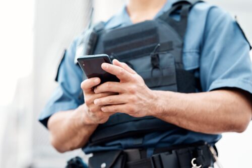 officer holds phone