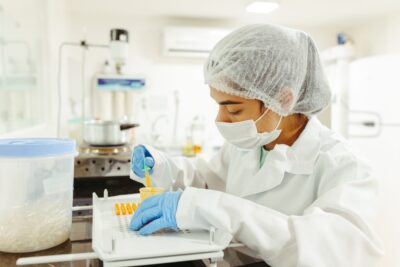 A researcher works in a laboratory, reflecting the skilled immigrants affected by growing employment-based green card backlogs and USCIS processing delays.