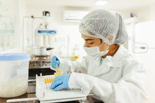 A researcher works in a laboratory, reflecting the skilled immigrants affected by growing employment-based green card backlogs and USCIS processing delays.